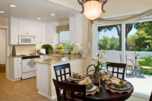 Kitchen and dining area with a patio outside sliding glass doors of an apartment at Royal Oaks 