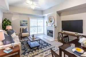 Large living room space with a fireplace in an apartment at Royal Oaks