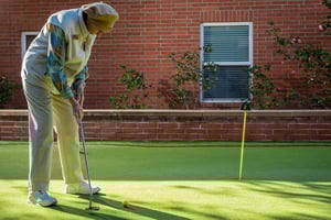 Senior on the putting green at Royal Oaks