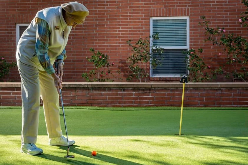 Senior on the putting green at Royal Oaks