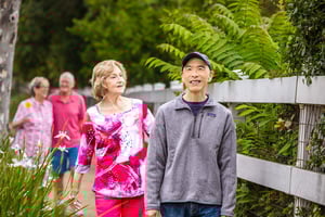 Two senior women and two senior men on a walk on the campus at Royal Oaks