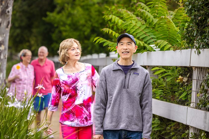 Two senior women and two senior men on a walk on the campus at Royal Oaks