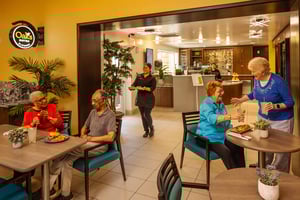 Seniors enjoying food at The Oaks bistro at Royal Oaks