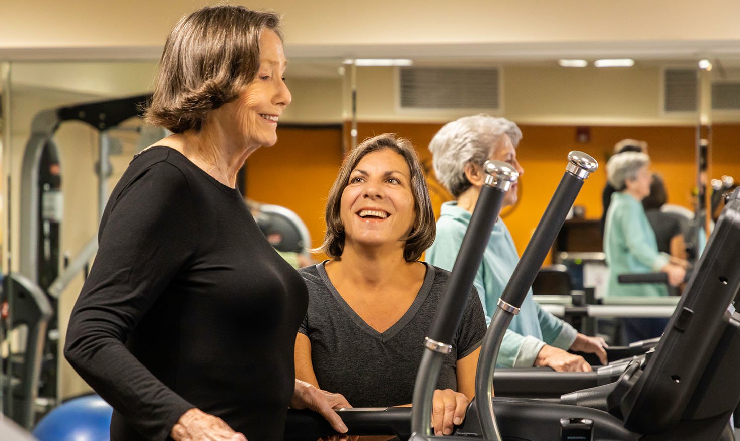 Senior women using exercise equipment in the Royal Oaks fitness center 