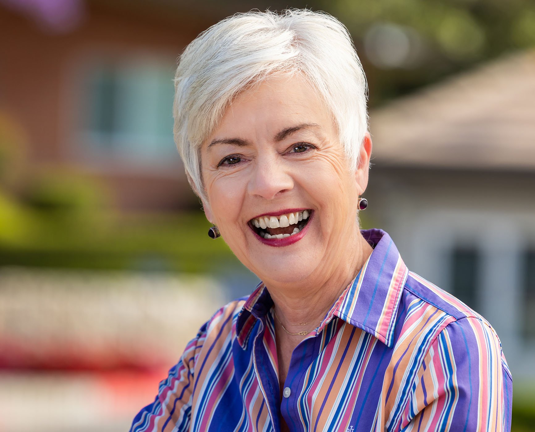Smiling senior woman in a striped button-up shirt
