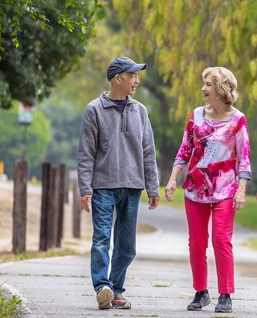 Senior man and senior woman walking on a trail at Royal Oaks