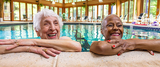 seniors smiling in an indoor pool