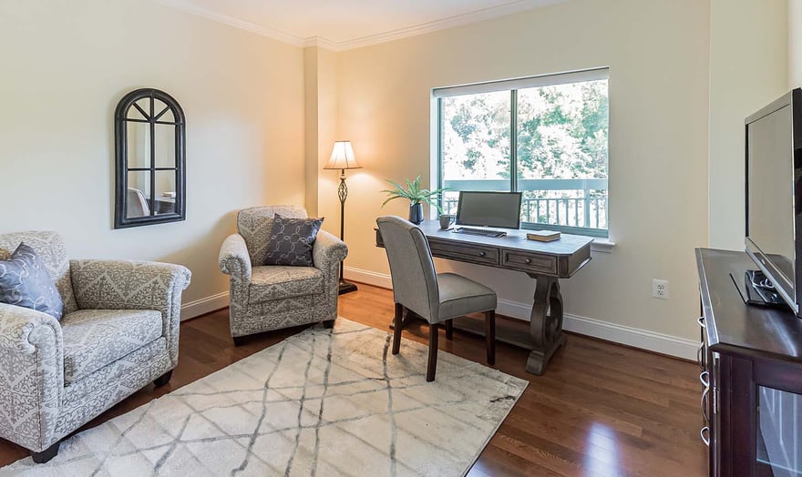 Office with a desk, rug and two armchairs in an apartment at Rydal Park & Waters