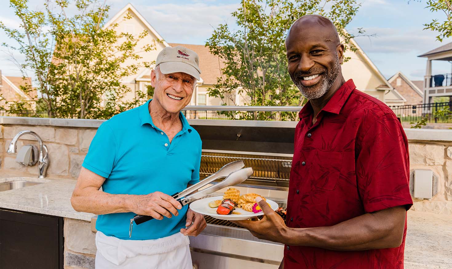Two senior men grilling at the barbecue