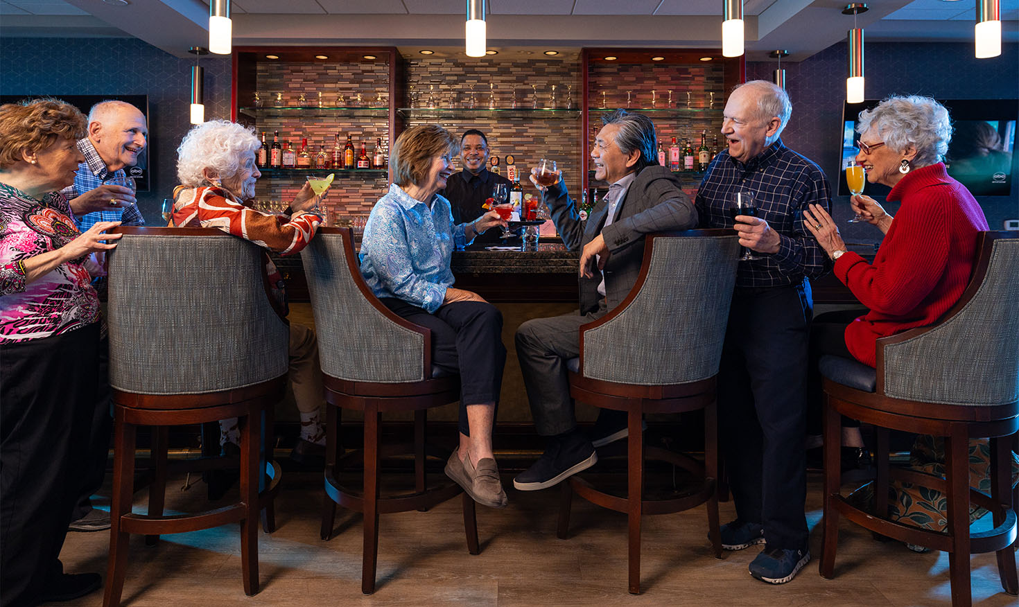 Seven seniors enjoying drink at the community bar
