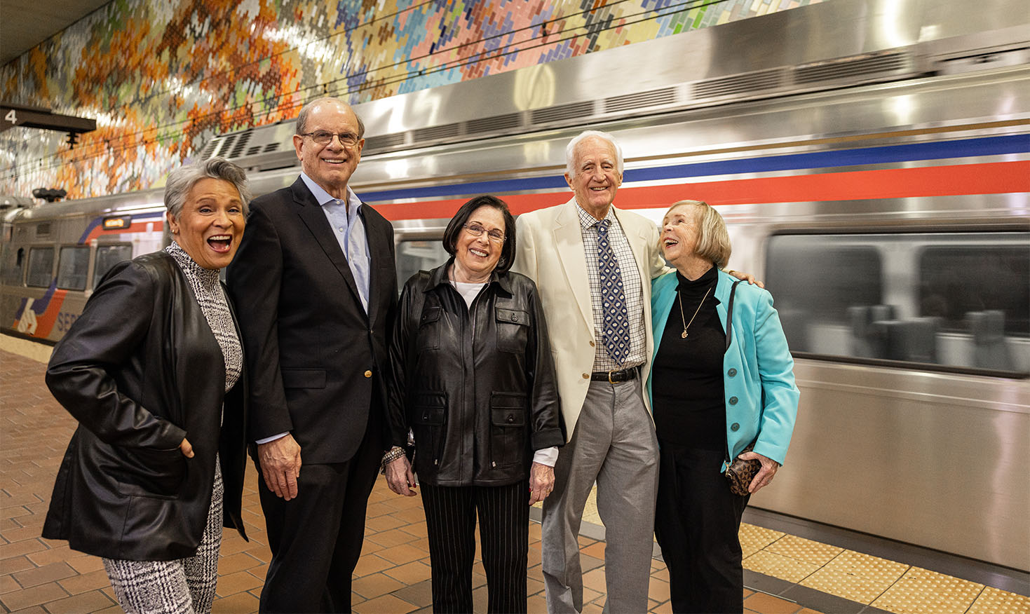 Five seniors at a train station