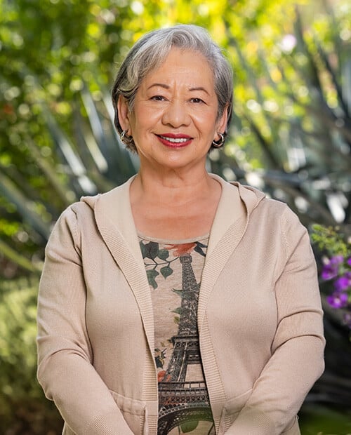 Smiling senior woman standing outside