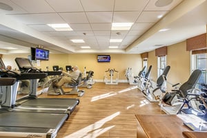Man using a recumbent bike in the fitness center at The Terraces at Los Altos