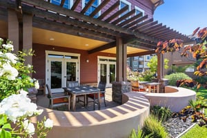 Tables and chairs under a pergola at The Terraces at Los Altos
