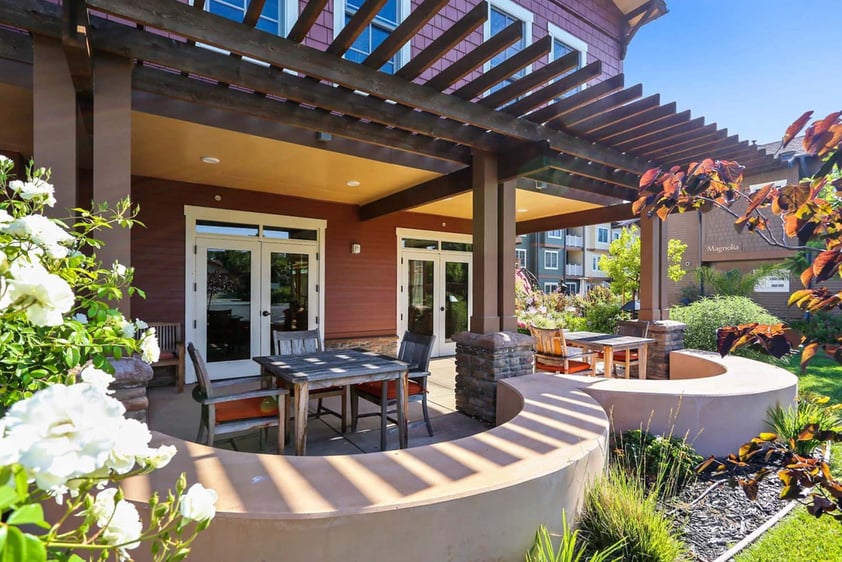 Tables and chairs under a pergola at The Terraces at Los Altos