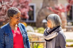 Two senior women talking outside