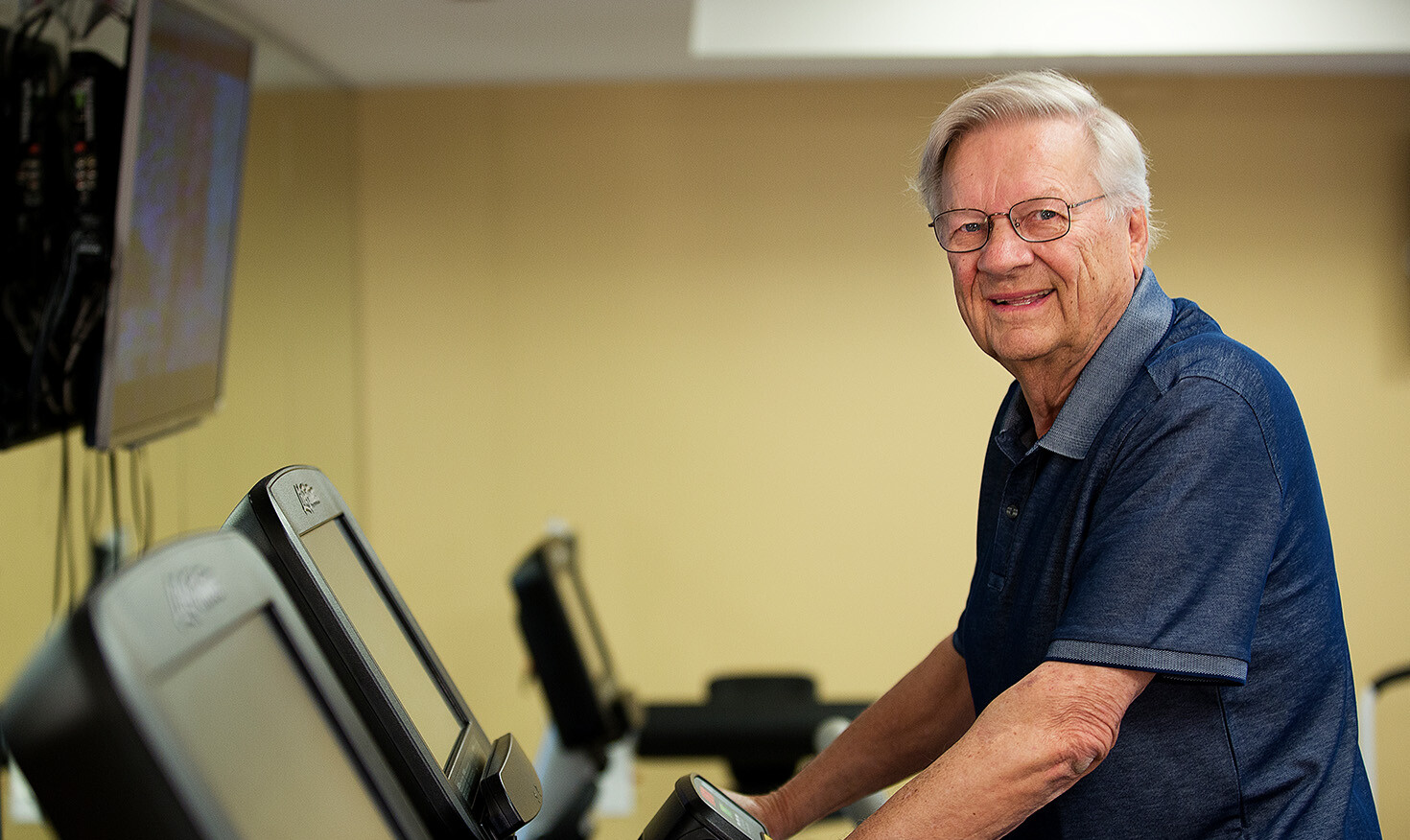 Senior man on treadmill in the fitness center at The Terraces at Los Altos
