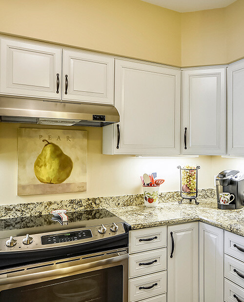 Stove and cabinets of a kitchen in an apartment at The Terraces at Los Altos