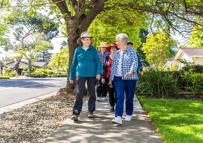 Group of senior friends walking down the sidewalk