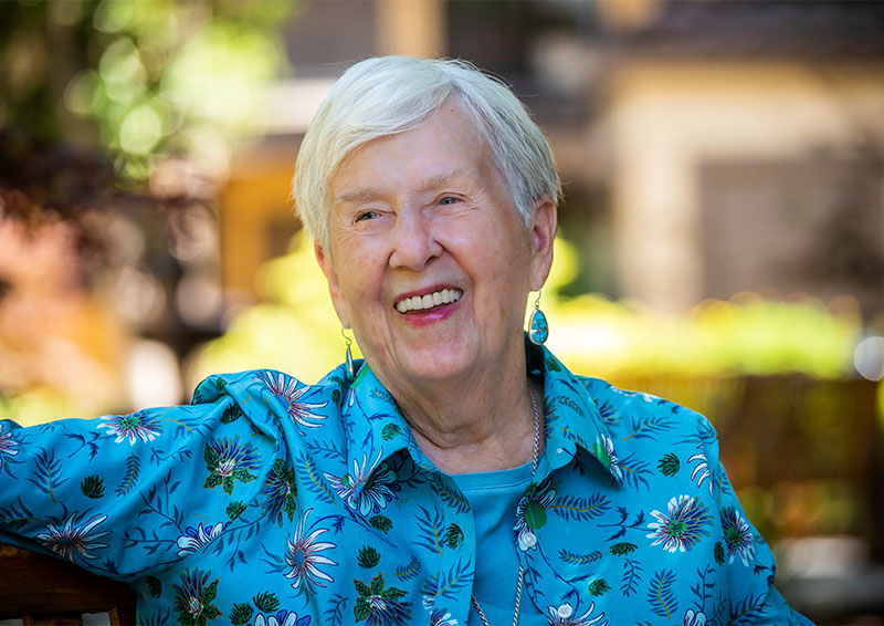 Smiling senior woman sitting outdoors