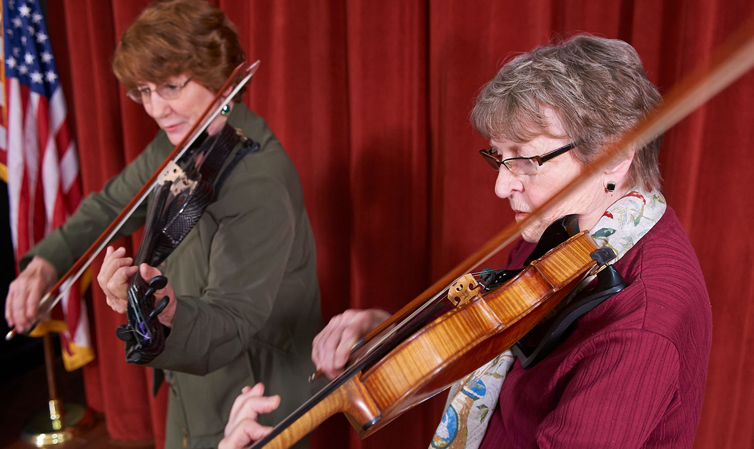 Two senior women playing musical instruments 