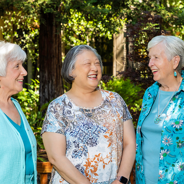 Three senior women having a conversation outside