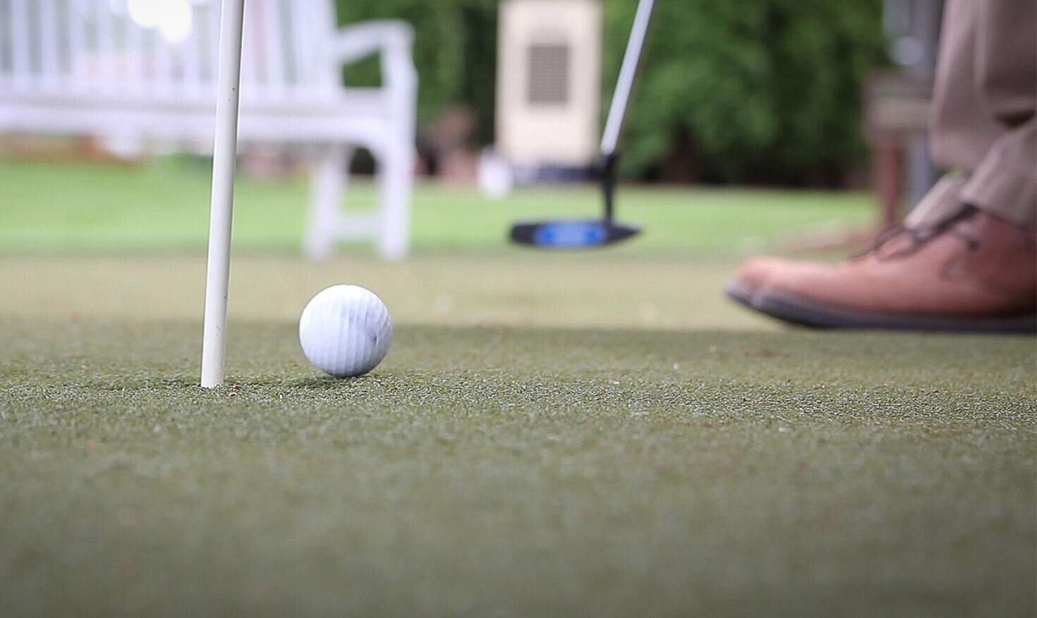Close-up of a person putting a golf ball