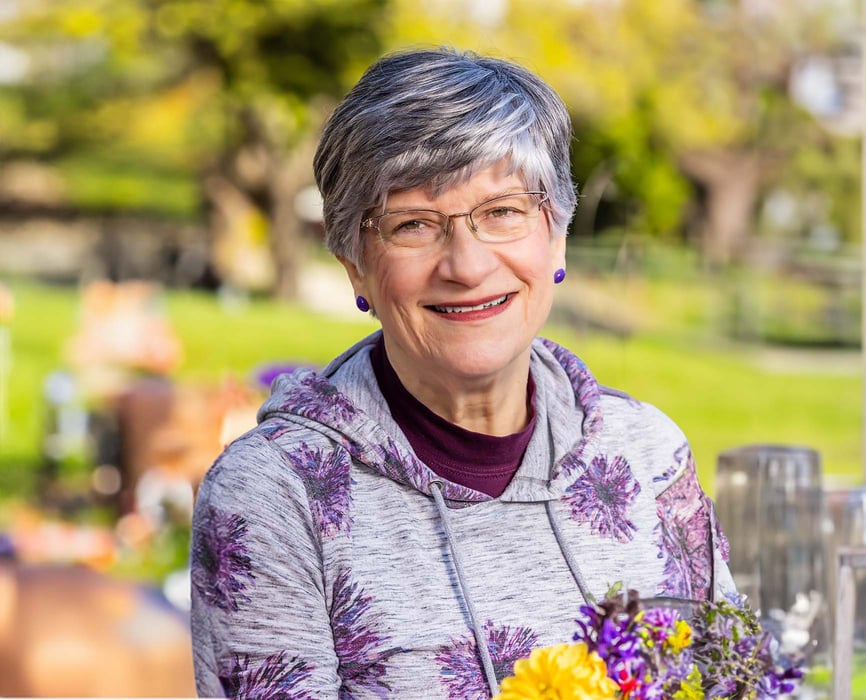 Smiling senior woman sitting outdoors at The Terraces at Summitview