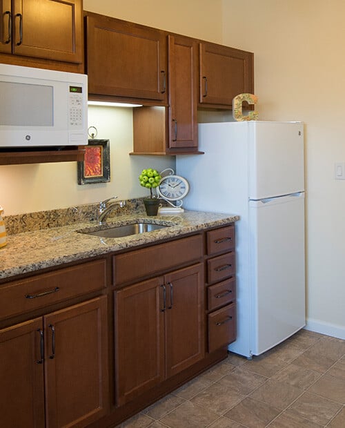 Kitchen in an apartment at The Terraces of Boise with a fridge, microwave and sink