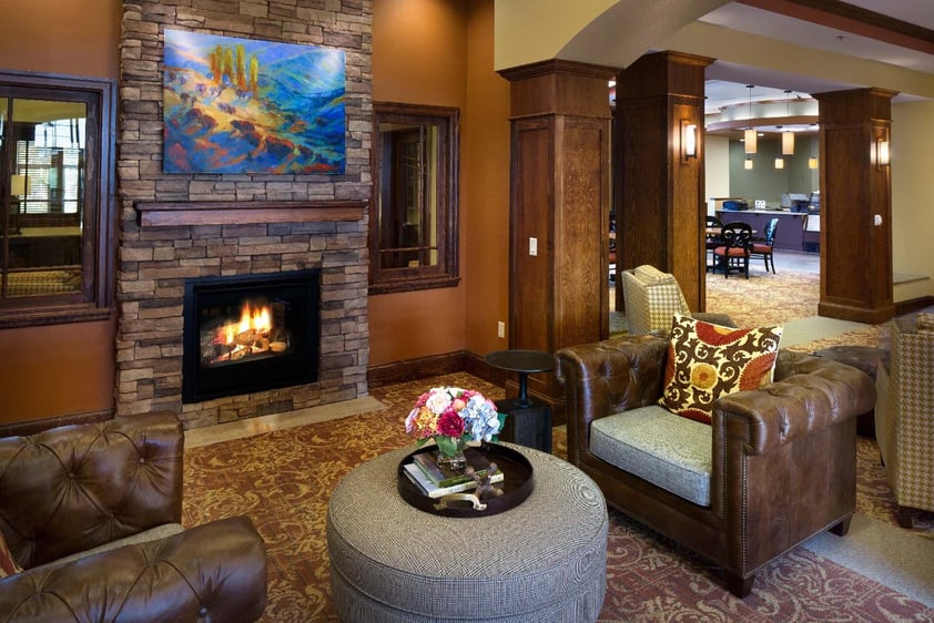 Large, warm seating area with a fireplace at The Terraces of Boise