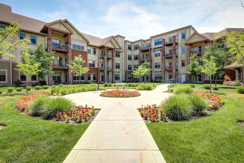 Walking path with a circular garden and apartment building at The Terraces of Boise
