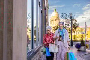 Two senior women shopping in Boise, Idaho, with the state capitol in the background