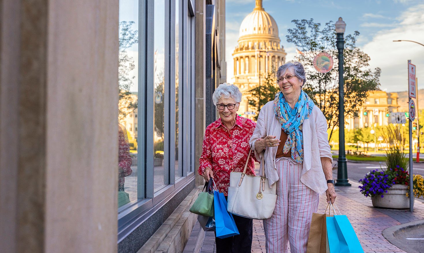 Senior women shopping in Boise, Idaho, with the state capitol in the background