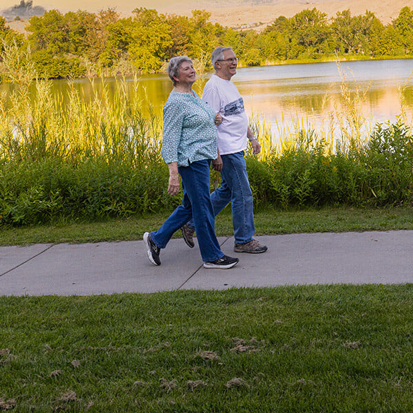 Senior couple walking next to a lake in Boise, Idaho