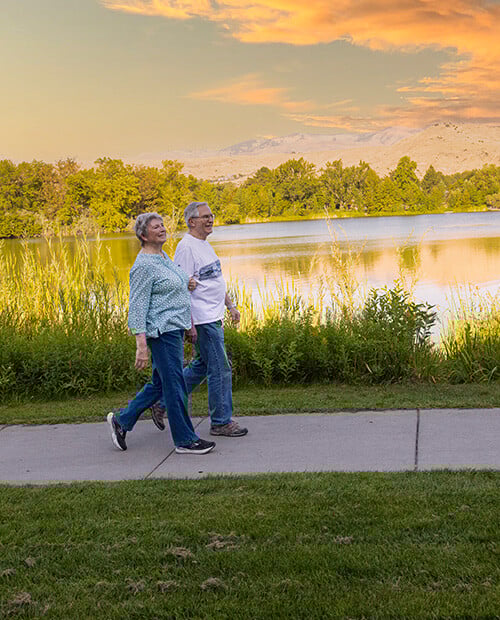 Senior couple walking next to the river in Boise, Idaho