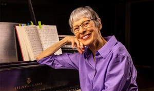 Senior woman sitting at a piano