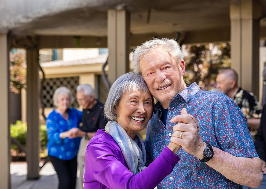 Senior couples dancing on a patio