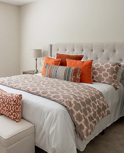 Bed with tufted headboard in an apartment