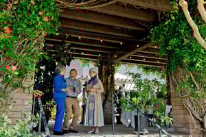 Three seniors enjoying drinks and chatting on the a patio at Valle Verde