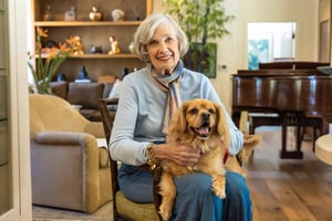 Senior woman sitting with a small dog in her lap