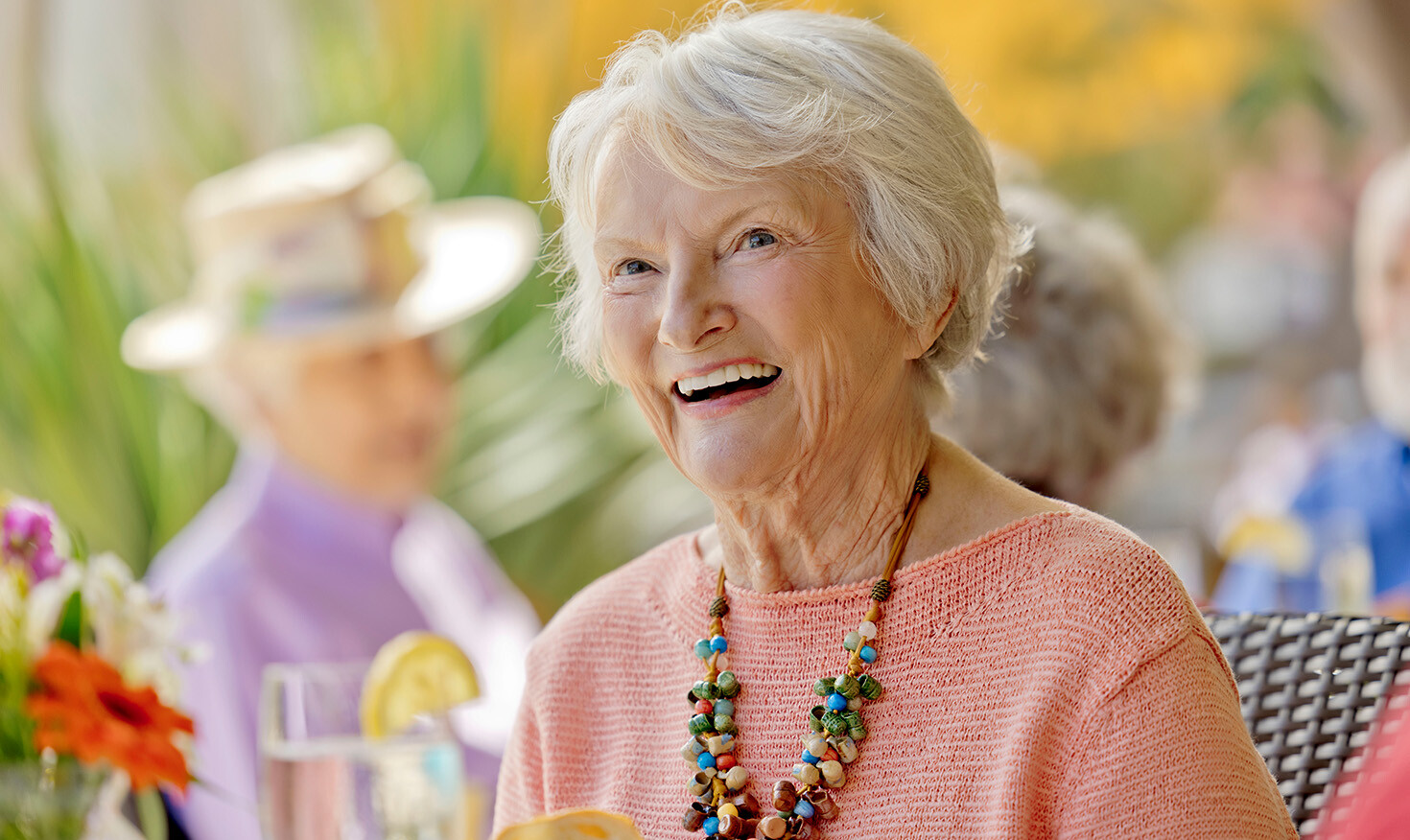 Smiling senior woman wearing a colorful beaded necklace