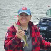 Dawn Armstrong holding a fish on boat
