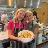 Lisa Holland wearing apron while holding a food dish