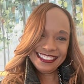 Lynn Marie Johnson smiling in front of painting