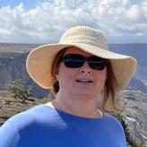 Suzanne Nagel wearing a hat while on top of a canyon