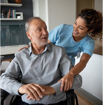 HumanGood Life Plan Community nursing team member helping a senior man in a wheelchair