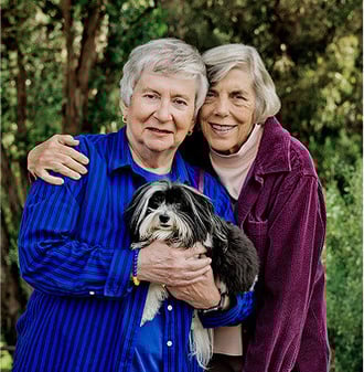 Two senior women with a small long-haired black and white dog