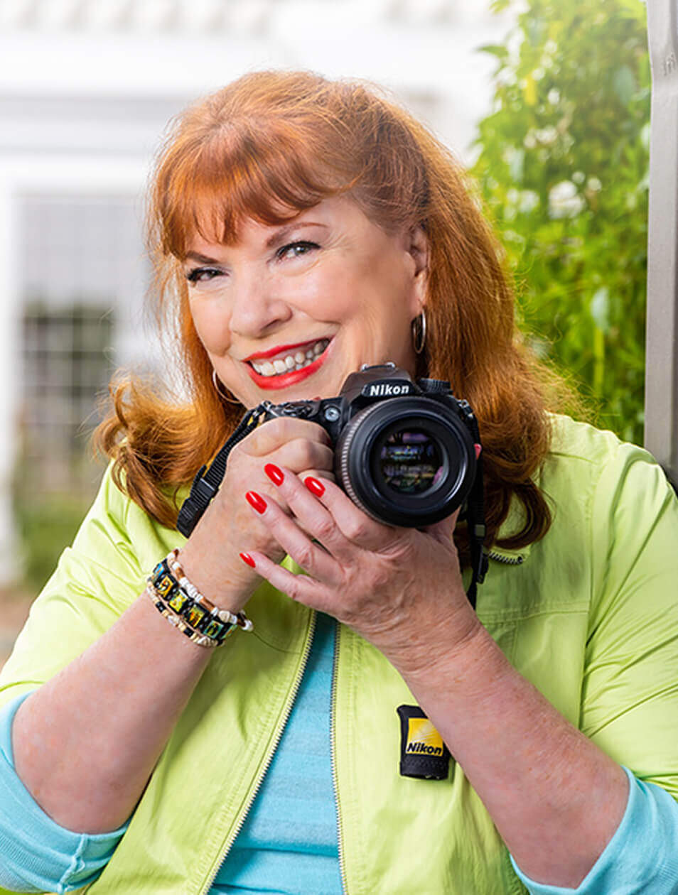 Senior woman holding a Nikon camera