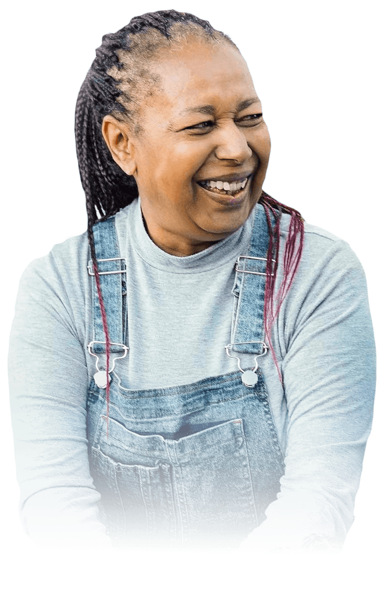 black senior woman in overalls smiling