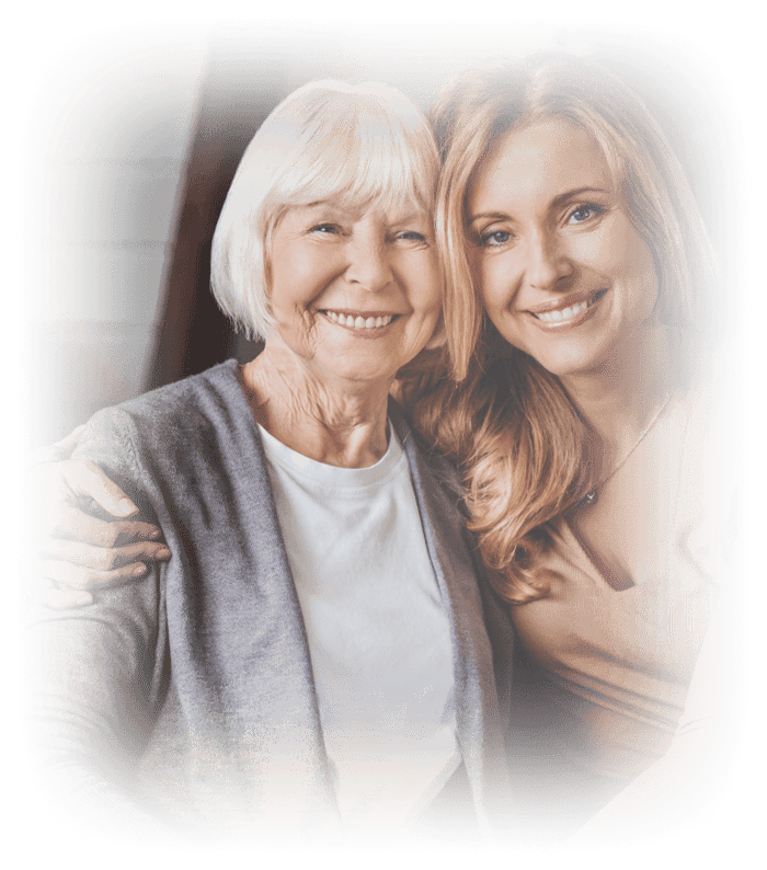 Senior woman posing for a photo with her adult daughter